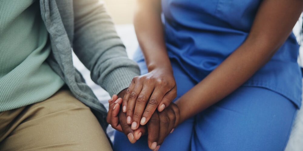 senior patient and nurse for healthcare, support and counseling in hospital bed